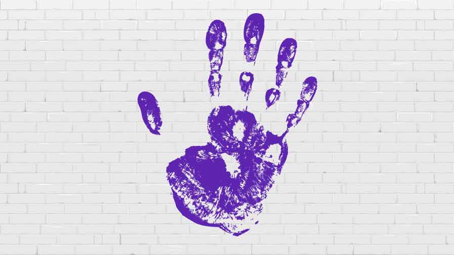 A purple hand print on a white wall