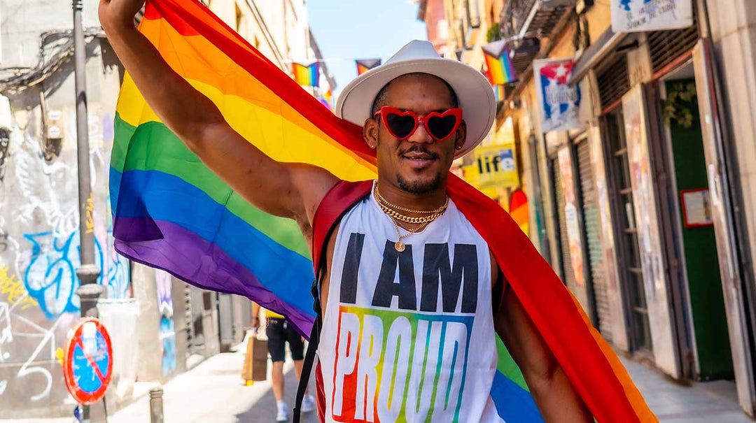 A man in a pride t-shirt with a pride flag